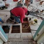 Man is repairing floor