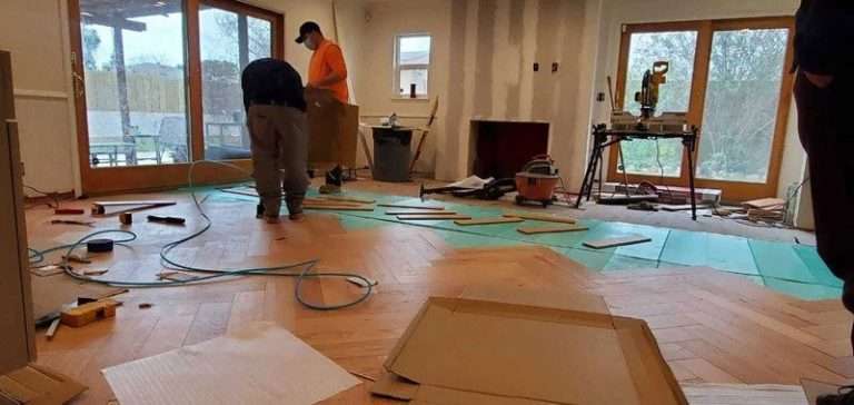 Golden Heights Remodeling team installing flooring tiles
